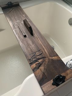 a wooden sign sitting on top of a bath tub