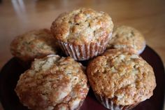 some muffins are sitting on a black plate