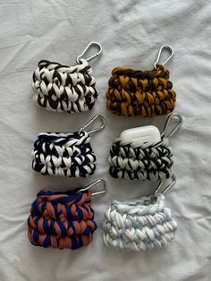 six different colors of braided hair clips on a white sheet with clippings