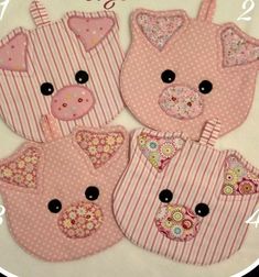 three little pigs are in pink and white striped bibs with black buttons on them