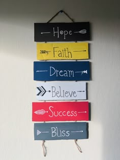 a sign hanging on the wall that says hope, faith, dream, believe and success