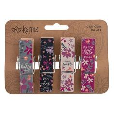 three clips with flowers and sayings on them in a card board packaging for the camera