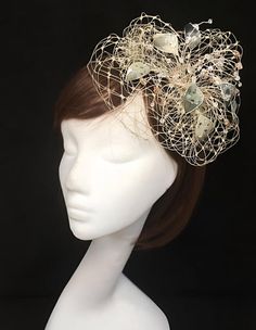 Delicate silver fascinator perfect for the guest who wants something fairly understated yet unique.  This design is a beautiful selection of glass effect leaves with a scatter of silver and oyster tone crystals clustered together amongst a fine layer of soft silver grey veiling and set onto a fine comfort fit tiara band. As with all our designs, this piece can be made exact to the image or in any colour combination to match in with your outfit. If a specific colour is required customers can mess Silver Fascinator, Silver Hat, Ivory Fascinator, Silver Hats, Mini Hats, Fascinator Hat, Fascinator Hats, Colour Combination, Color Swatches