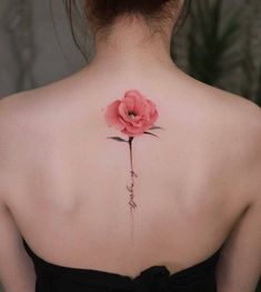 a woman with a pink flower on her back