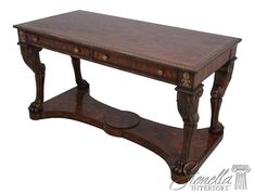 a wooden table with two drawers on one side and an ornate design on the other