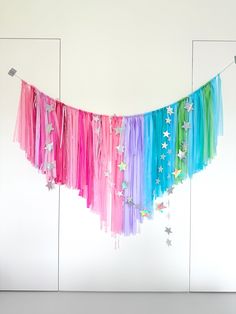 there is a colorful streamer with stars hanging from it