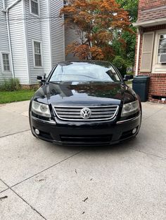 a black car parked in front of a house