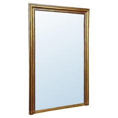 a gold framed mirror on a white background