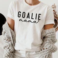 Every Goalie Mom needs this super soft and cozy T-shirt for Hockey, Soccer or Lacrosse game days! Welcome to my store! Everyone needs the perfect t-shirt to complement an everyday, laid-back look. The ideal top for so many occasions, this lightweight cotton tee will keep you comfy and looking smart. * 100% combed and ring-spun cotton (Heather colors contain polyester) * Fabric weight: 4.2 oz/yd² (142 g/m²) * Pre-shrunk fabric * Side-seamed construction * Shoulder-to-shoulder taping * Blank produ Goal Keeper Mom Shirt, Goalie Mom Svg, Comfortable Fit White Soft-washed Tops, Comfortable Fit Soft-washed White Top, Comfortable Soft-washed White Top, White Soft-washed Top With Comfortable Fit, Goalie Mom Shirts, Sports Treats, Goalie Mom