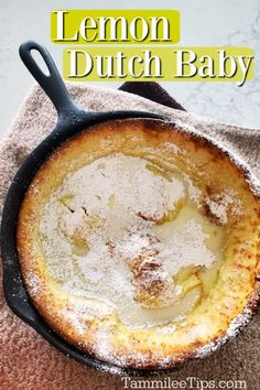 lemon dutch baby in a cast iron skillet with powdered sugar on top