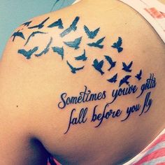 the back of a woman's shoulder with birds on it and some words written in black ink