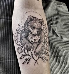 a bear and cub tattoo on the leg