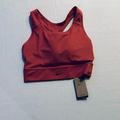 Nike Swoosh Womens Medi-Support Padded Sports Bra Salmon Color Size Large Casual Go-dry Sports Bra For Light Sports, Nike Solid Color Sports Bra, Nike Solid Sports Bra For Sports, Nike Solid Activewear For Sports, Nike Activewear For Sports, Red Casual Sports Bra For Running, Casual Athletic Fit Sports Bra, Nike Casual Sports Bra For Training, Casual Nike Racerback Sports Bra