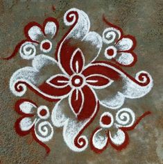 a red and white flower is painted on the ground with some paint sprinkles