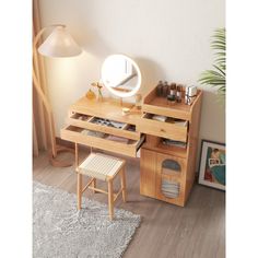 a wooden desk with drawers and a mirror on top of it next to a lamp