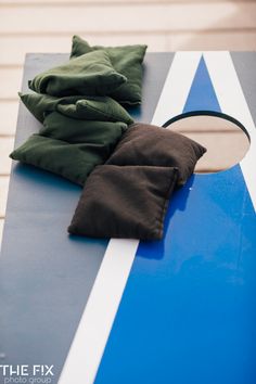 a pair of black pants sitting on top of a blue and white board