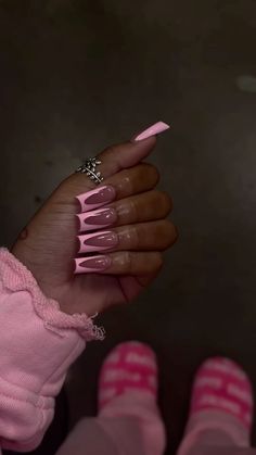 a woman's hand with pink nail polish on it