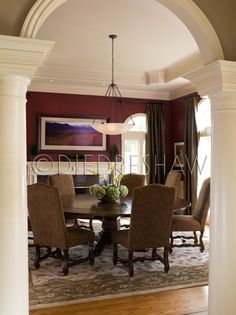 an archway leads into a formal dining room