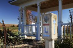 a white house with a clock on the front porch