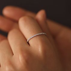 a woman's hand with a diamond ring on it