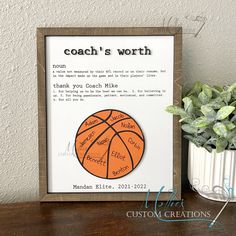 a wooden frame with a basketball on it next to a potted plant and a sign that says coach's worth