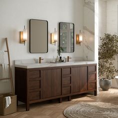 a bathroom with two sinks, mirrors and a rug on the floor in front of it