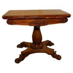 a wooden table with an ornate design on the top and base, against a white background