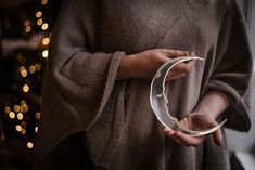 a woman is holding an object in her hands