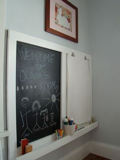 a chalkboard with writing on it in the corner of a room