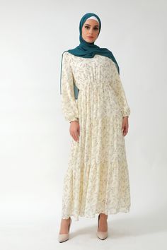 The Cream Floral Tiered Maxi Dress is a master of all traits. It's lovely daisy floral print on a cream chiffon canvas. Featuring a tiered hem and elastic cuff to make wudu easy. Fully lined to ensure it's not see through. Paired with our Beige Chiffon hijab Fully Lined 100% Premium Chiffon Elastic Waistband V neckline Fit and Flare Model is 5'10" wearing a size small Elegant Abayas, Chiffon Hijab, Casual Day Dresses, Evening Gowns Elegant, Tiered Maxi Dress, The Cream, Modest Dresses, Modern Fashion, Modest Fashion