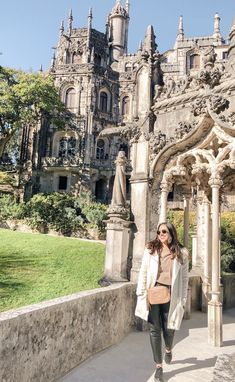 a woman walking in front of an old building