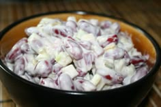 a bowl filled with lots of white and red food