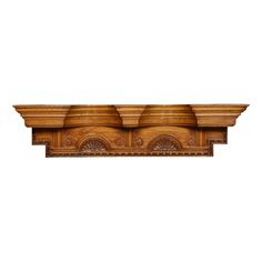 a wooden shelf with carvings on it