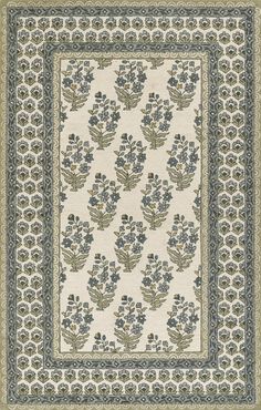 a white rug with blue and green flowers on the bottom, in front of a beige background