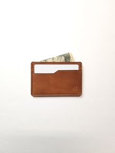 The Slim Wallet is one the most simplistic wallet styles offered. It features three pockets, two on the outside that allow for easy access to cards and one in the middle for stashing cash or more cards. Material: Full-Grain American Leather Dimensions: 3.8in x 2.80in Holds 4-6 cards and some bills. Handcrafted in Alabama, USA -Because leather is an organic material, there will be variations in color & texture from piece to piece. Classic Card Holder With Coin Pocket For Everyday Use, Classic Trifold Wallet With Card Slots For Everyday, Classic Brown Card Holder With Phone Sleeve, Classic Bifold Coin Purse For Everyday, Classic Trifold Wallet With Cell Phone Pocket For Everyday, Everyday Trifold Wallet With Hidden Phone Sleeve, Classic Rectangular Wallet With Flat Pocket, Classic Rectangular Card Holder With Cell Phone Pocket, Classic Bifold Card Holder With Flat Pocket