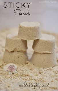 sand castle made out of small rocks and seashells with the words sticky sand written on it