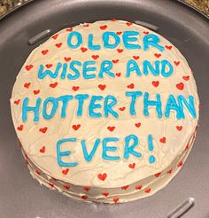 a birthday cake with the words older wise and hotter than ever written on it