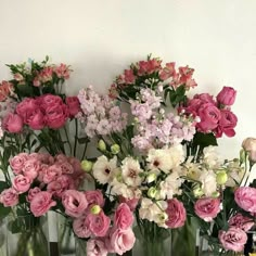 several vases filled with pink and white flowers