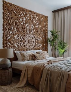 a bed sitting next to a window with a wooden head board on it's side