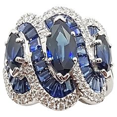 Blue Sapphire 1.93 carats (Center Marquise) with Blue Sapphire 1.55 cts (Total Side Marquises) with Sapphire 7.92 carats (Total Baguette) and Diamond 0.57 carat Ring set in 18 Karat White Gold Settings Width: 2.0 cm Length: 2.0 cm Ring Size: 52 Total Weight: 11.33 grams "We first opened doors in 1980 when it was then situated in the vicinity of the Victory Monument; a small and modest storefront with a couple of counters. From its humble beginnings to where it stands today, our company has prove Luxury Blue Marquise Cut Jewelry, Luxury Blue Marquise Cut Ring, Dazzling Blue Diamond Gemstones, Blue Sapphire Ring With Multi-stone Baguette Cut, Blue Sapphire Multi-stone Baguette Ring, Blue Multi-stone Baguette Cut Sapphire Ring, Blue Multi-stone Platinum Jewelry, Luxury Blue Marquise Rings, Luxury Blue Marquise Jewelry