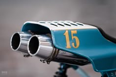 the front end of a blue bicycle with a number 15 on it