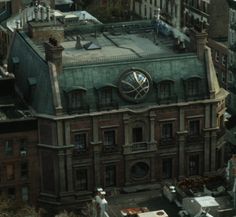 an old building with a large round window on it's roof in the city