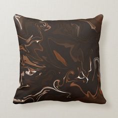 a black and brown pillow with white swirls on it