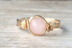 Beautiful Rose Quartz Ring! These pale pink Rose Quartz gemstones measure 6 mm each. They are wrapped in 14k Gold Filled wire and can be made in any size, from 2-15, in whole, half, or quarter sizes. Click here to see our matching Rose Quartz ear threaders: https://www.etsy.com/listing/664364478/rose-quartz-threader-earrings-quartz?ref=shop_home_active_1&pro=1&frs=1 Wire Wrapped Gemstone Jewelry, Crescent Moon Necklace Gold, Double Horn Necklace, Wire Jewelry Rings, June Birthstone Ring, Gold Pearl Ring, Ring Wire, Quartz Gemstones, Wire Wrapped Ring