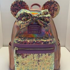 Nwt. Shiney Rose Gold Backpack With Sequined Front Pocket, Bow And Ears. Dark Pink/Rose Straps, Reinforcements For Zippers And Loungefly Tag. Approx. 10 1/2 Tall, 6 1/4 Inch Wide And 9 1/2 Inches Across. Disney Loungefly Backpack Display, Backpack Display, Disney Loungefly Backpack, Loungefly Purse, Backpack Collection, Loungefly Backpack, Disney 50th Anniversary, Disney Bags