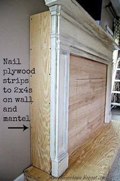 an unfinished fireplace surround with nails and plywood strips to attach the trim on the mantle