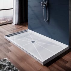 a bathroom with a walk in shower next to a wooden floor and window overlooking the city