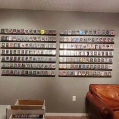 a living room filled with furniture and lots of dvd's on the wall behind it