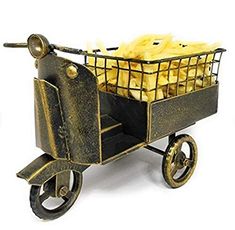 a small metal cart filled with potatoes sitting on top of a white surface