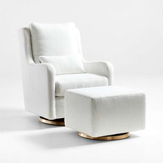 a white chair with a footstool and ottoman